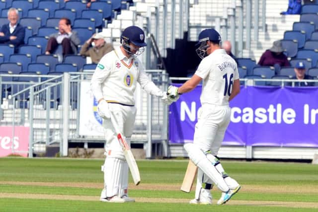 Mark Stoneman gets congratulated on his 50 by Scott Borthwick