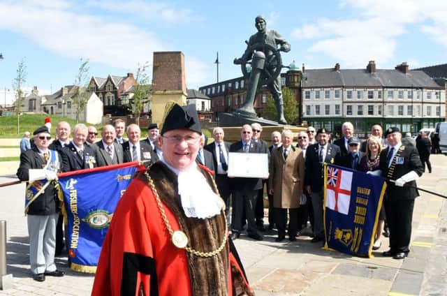 The former Mayor of South Tyneside, Coun Richard Porthouse, at the Merchant Navy Memorial in Mill Dam with former crew members of South Tynesides adopted ship HMS Euryalus.