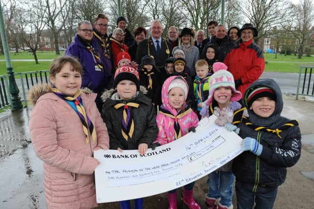 Youngsters from 22nd Brownsea Beaver's with their cheque for £176 being handed over to Friends of the West Park.