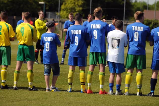 The first Aaron Todd Memorial Shield football match between Jarrow FC and Robertson Scaffolding - players hold a minute's applause