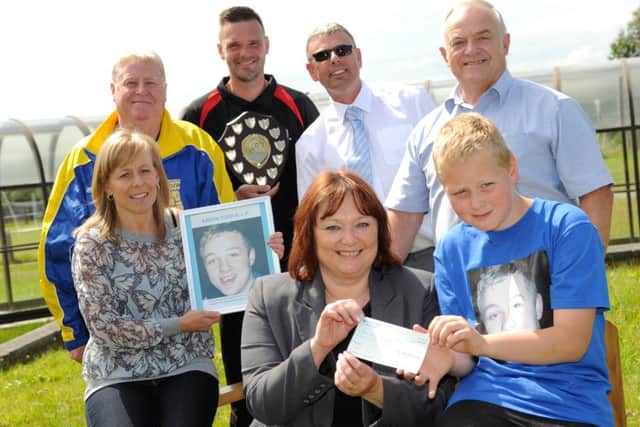 Aaron Todd's brother Ronni Rutter, right, hands a cheque for Â£1200 to Newcastle Hospital's Pauline Buglass, with left to right, Karen Rutter, Steve Dean, Chris Thompson, Coun Lee Hughes, and Bob Wilson