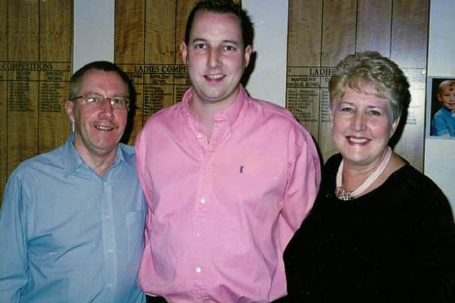 Paul Wilson, centre, pictured with his parents.