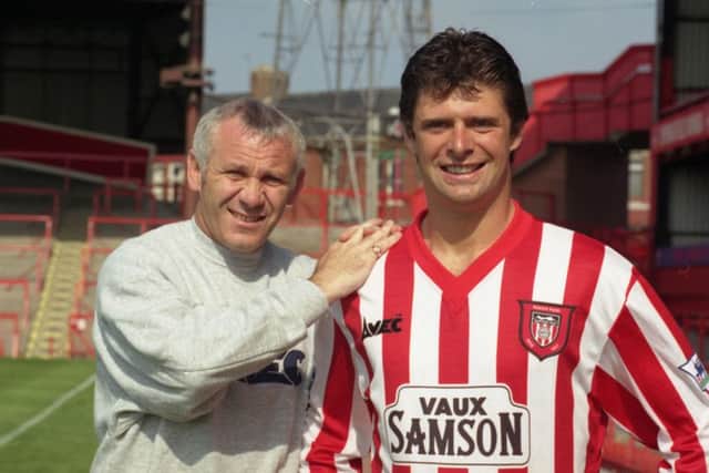 Niall Quinn signs for Sunderland, with Peter Reid pic by Malcom Murray 15 August 1996 old ref number 36224
picture caption: Niall Quinn finally became a Roker player today in £1.3m record deal. Boss Peter Reid helps new boy Niall Quinn settle in at Roker Park Sunderland Echo Thursday August 15 1996