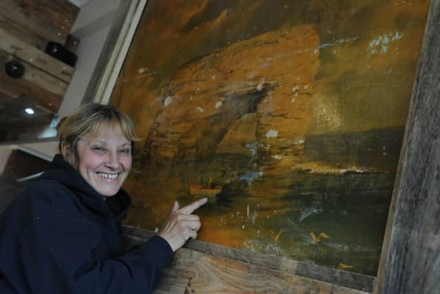 Valerie Simpson looking at the picture of Marsden Rock, that has been uncovered during the reburbishment of the White Horse pub, Quarry Lane, South Shields.