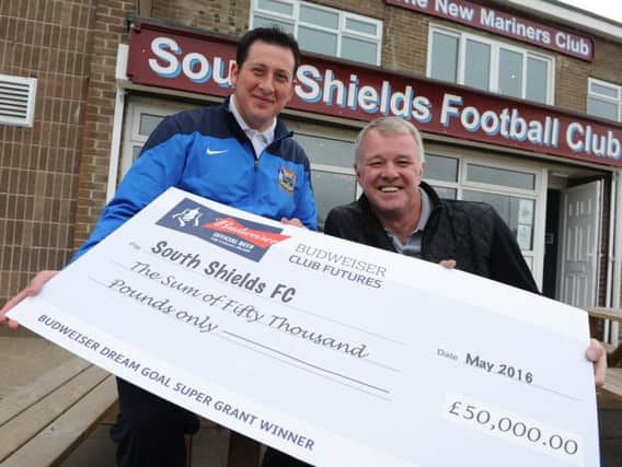 South Shields striker Warren Byrne receives the 50,000 cheque from former Manchester United defender Gary Pallister