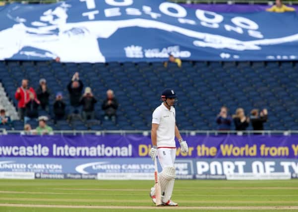 A sparse crowd and large banner recognise England's Alastair Cook  scoring 10,000 test runs