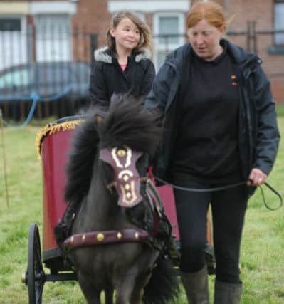 Emily Veitch takes a mini chariot ride at the fun day.