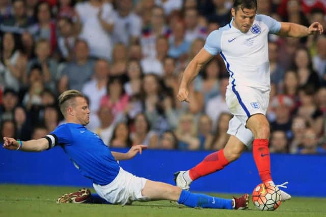 Mark Wright goes past a Rest of the World defender during the Soccer Aid game.