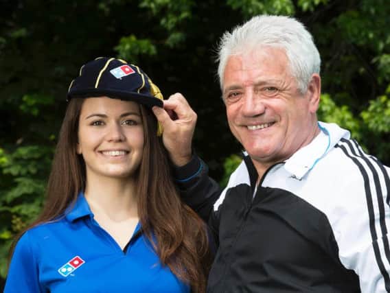 Former England football player and manager Kevin Keegan "caps" new employee Eva Juhasz, as she joins the Domino's team, which marks the pizza chain's creation of 10,000 new jobs to deal with demand from football fans during UEFA Euro 2016. Picture by: Jon Super/PA Wire