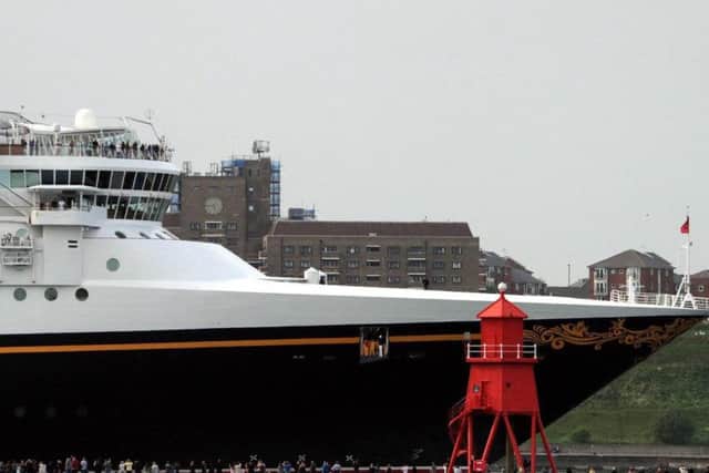 Well wishers look on from the Groyne in South Shields as Disney Magic departs the North East.