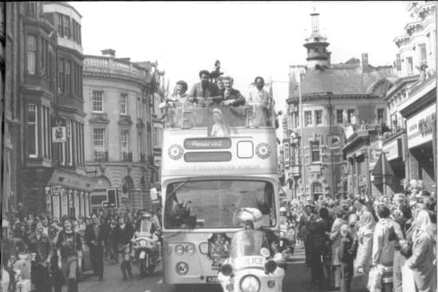 Muhammad Ali rides through South Shields on an open top bus in July 1977.