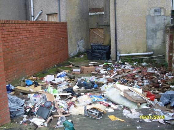 The rear yard of one of the properties before the council arranged for it to be cleared.