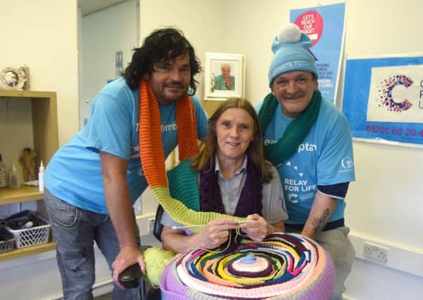 Charity knitters Mark Young (left) and John Stewart (right) with  relay organiser Ann Walsh.