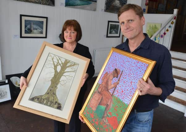 Hawthorn Arts boss Graham Hodgson with artist David Mcleod's work and Linda Weetman.