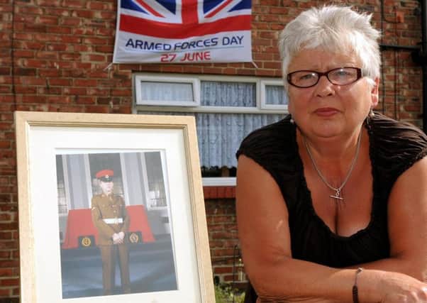 Pat Long  with a photograph of her son Corporal Paul Long, who died in Iraq in 2003.