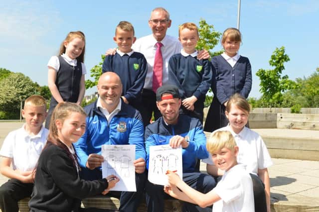 South Shields manager Jon King and player Barrie Smith with children from Stanhope Primary School, who provided many of the 160+ entries, and the schools headteacher John Vasey.