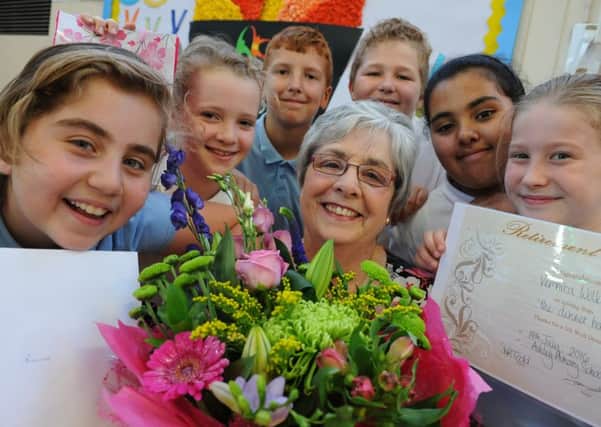 Dinner nanny Roni Wilkinson receives flowers and presents from Ashley Primary School pupils, to mark her retirement.