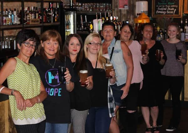 Tinkler Smith staff and charity organisers raise a glass to fund-raising.
