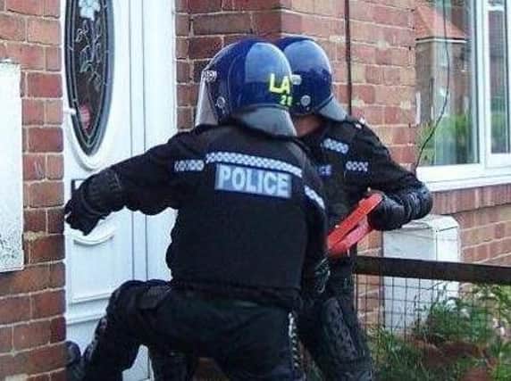Durham Police officers raid a home as part of the investigation into suspected drug dealers.
