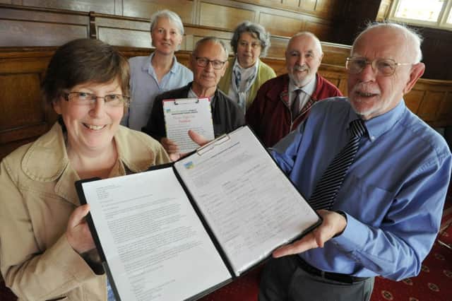 The petition is handed to Coun Allan West at Jarrow Town Hall, watched by members of the Tyne and Wear Public Transport Users Group.