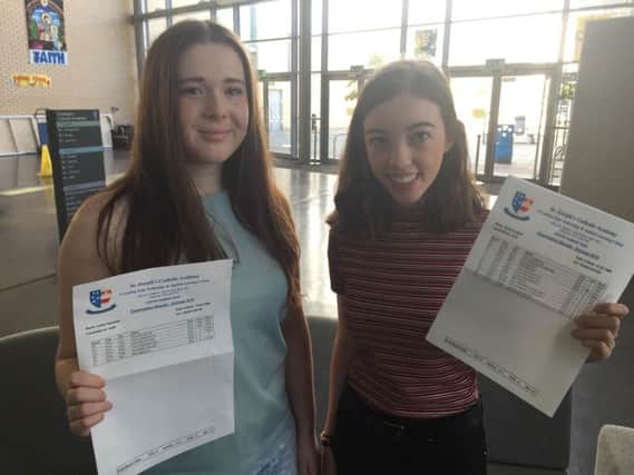 St Joseph's Catholic Academy Sixth Form pupils collect their A-level results. Caitlyn Marshall, left, and Rebecca Ward.