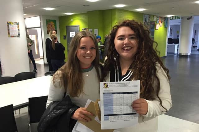 Hebburn Comprehensive School pupils Lucy Bell, left, and Kate Palmer collect their GCSE results.