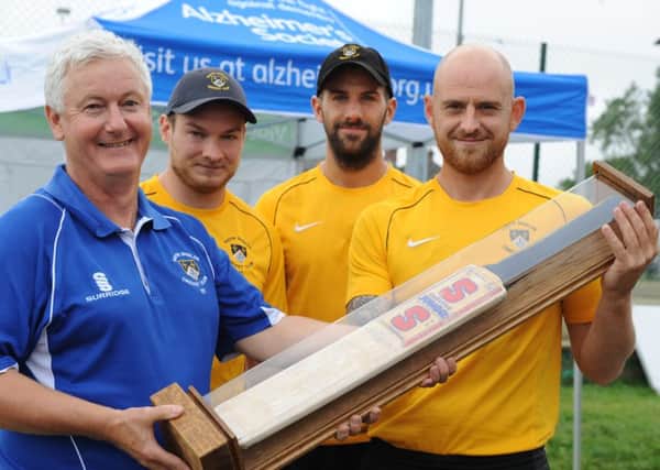 South Shields Cricket Club chairman jim Elliott with First XI team members Sam Embleton, Chris Stewart and Michael Dunn, with one of Bill Parker's old bats, which has been into a comemorative trophy for the event.