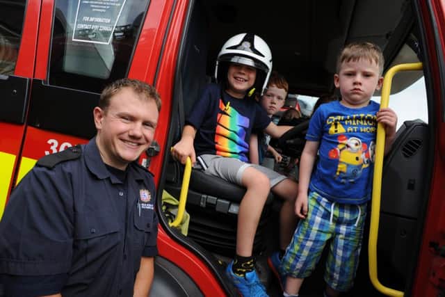 Firefighter Chris Scragg with youngsters Blake Martin, Toby and Charlie Hargreaves at Hebburn Fire Station open day.