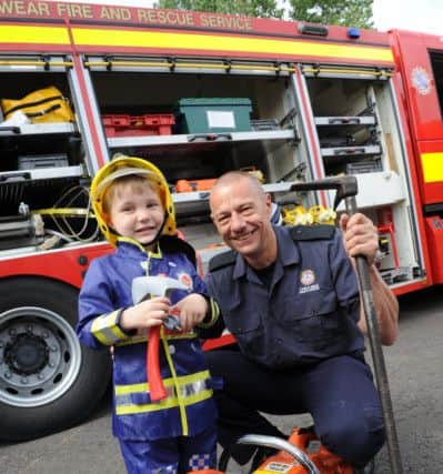 Firefighter Gary Smith and youngster Cameron Spoors at Hebburn Fire Station open day.