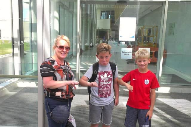 Clare Storey, son James (right) and his pal Oliver have given the leisure centre closure the thumbs-down.