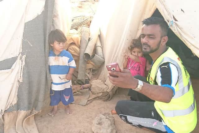 Shah Lalon Amin with children at one of the camps near the Syrian border in Jordan.