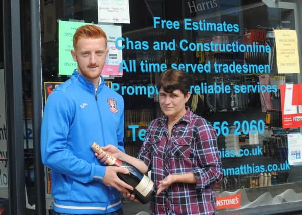 South Shields midfielder David Carson picks up the clubs Player of the Month award for August from Kathleen Butterfield, of sponsors Shaun Matthias.