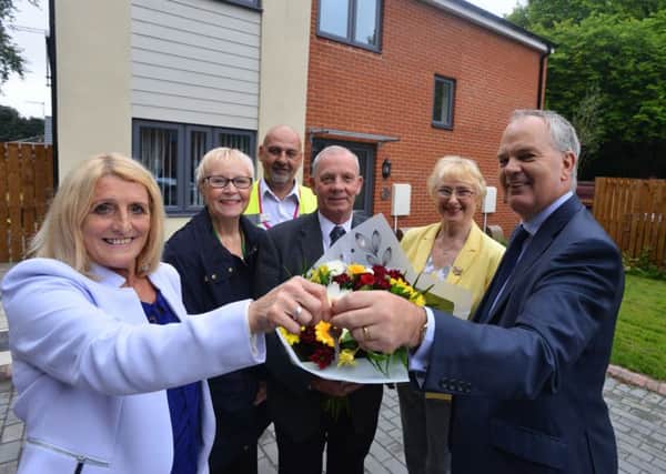 West Way resident Margaret Hay receives keys from South Tyneside Housing Trust Brian Scott., watched by, back, from left, Coun Anne Hetherington, Home Officer Colin Scope, Coun Norman Dick and Coun Gladys Hobson.