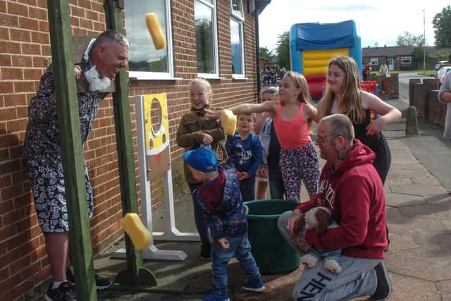 Youngsters take aim at councillor Hughes during the fun-packed pub event.