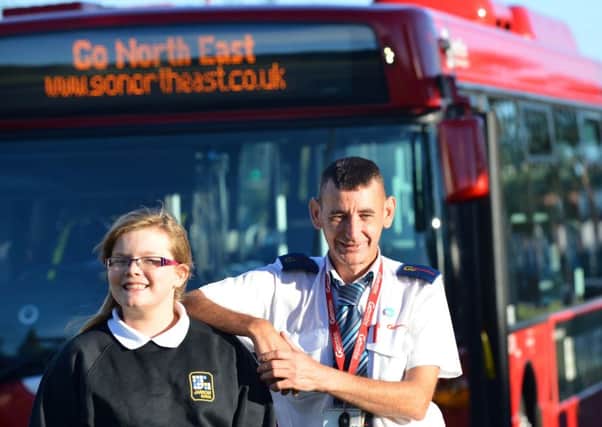 Schoolgirl Abigail Brunton aged 11 with bus driver Ken Waterson who paid her fair to school.