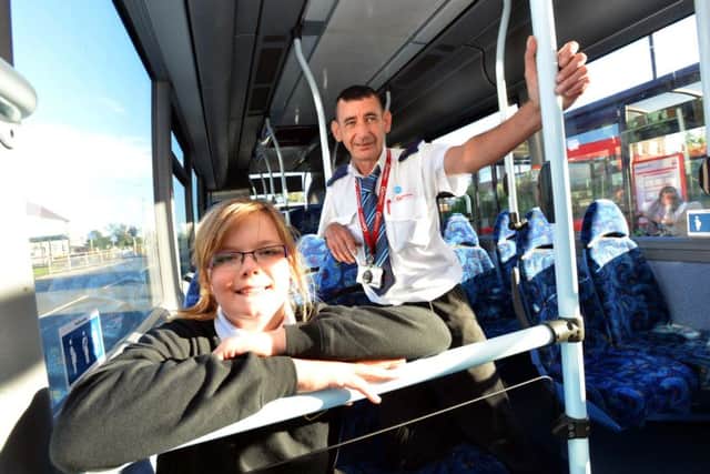 Schoolgirl Abigail Brunton aged 11 with bus driver Ken Waterson who paid her fare to school.