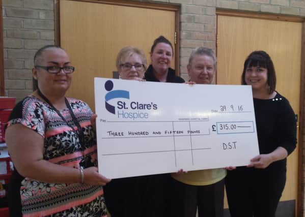 With the donation are, from left, Sharon Jemma from DST, Pauline Jameson, St Clares Hospice Day Centre patient, Emma Hudson, from DST, Agnes Campbell, St Clares Hospice Day Care patient, and Caroline Breheny, St Clares Hospice fundraiser.