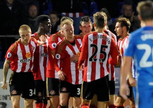 Donald Love is congratulated on his goal