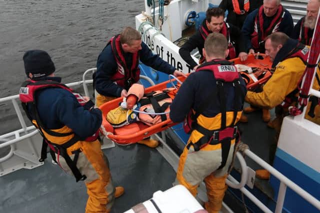 An injured 'casualty' is evacuated on a stretcher from the ferry onto the RNLI lifeboat. Please Credit:  Adrian Don/RNLI