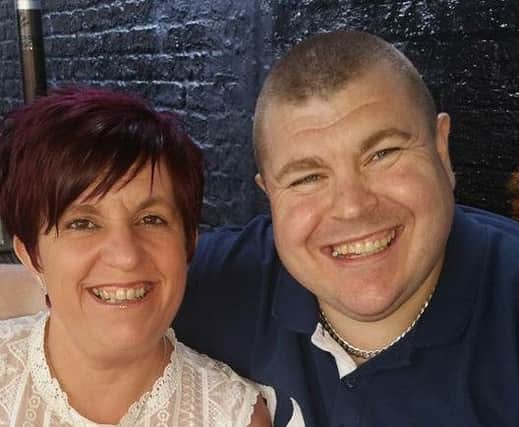 Christopher Perry, right, with wife Lisa, who have been devastated after his mobility scooter was stolen while they were away in Manchester.