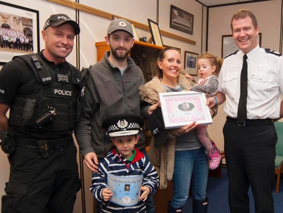 Nicole, her brother Louis, mum Gail and dad Matthew with Chief Constable Steve Ashman and dog handler Pc Steve Henry.