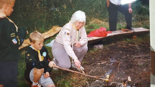 Cubs from 7th lighting fires with the help of leader Marjorie  Perriman.