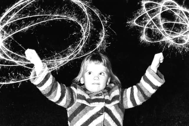 Five-year-old Emma Louise Lynn enjoys her sparklers at the Bents Park fireworks display.