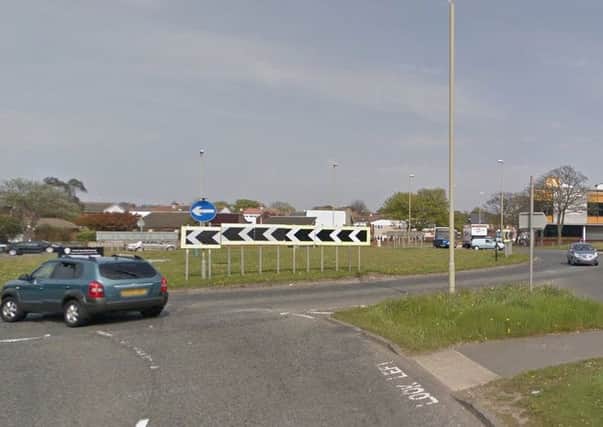 Police are hunting for the driver of a car which ended up on its roof on this roundabout.
