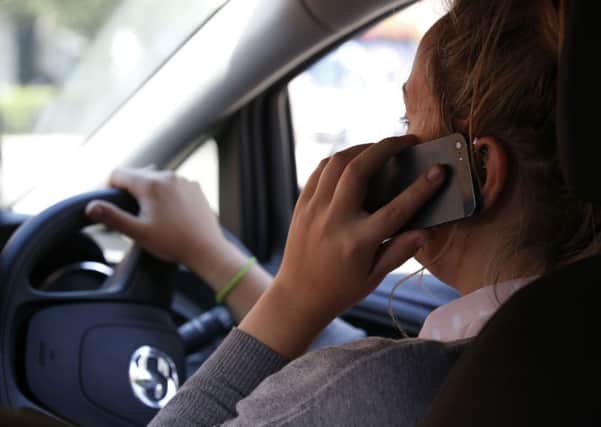 Calls have been made to take more action against drivers who use their phone while behind the wheel.