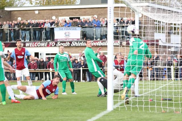Carl Finnigan watches on as his header - just about - crosses the line for South Shields against Marske United. Image by Peter Talbot.
