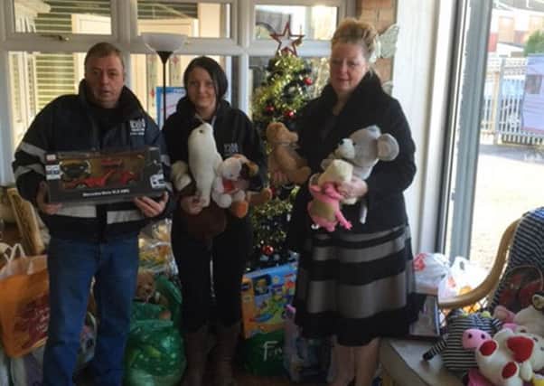 Staff from D&H Windows with Viv Watts, from Hope 4 Kidz, and some of the gifts donated to last year's appeal.