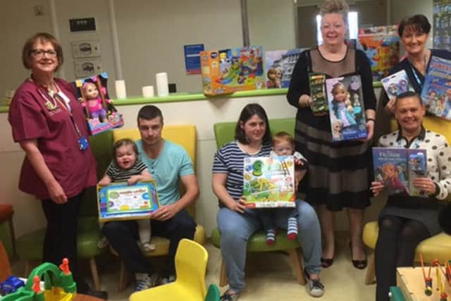 Children at South Tyneside Hospital were among those to receive gifts last year Pictured are, left to right, Nurse Practitioner Alison Sopp, Robert Thomas with his daughter Imogen Thomas, Chrystal Burns with her son Ivan Purdey, sitting, Ward Clerk Maureen Brand and Ward Sister Fiona Kerr and, standing, Viv Watts, from Hope 4 Kidz.