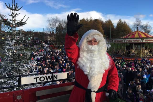 Father Christmas waves to the crowd at Beamish Museum.