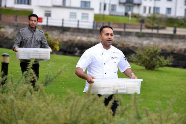 Monsoon owner Showkoth Choudhoury and other staff from the restaurant loaded the food onto the helicopter.